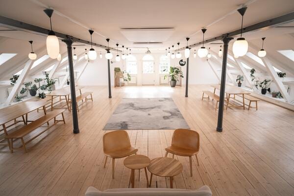 Spacious function room with natural light, ideal for workshops and networking events.