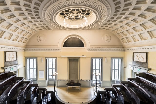 Elegant Main Hall in DIS Copenhagen, featuring high ceilings for conferences and lectures.