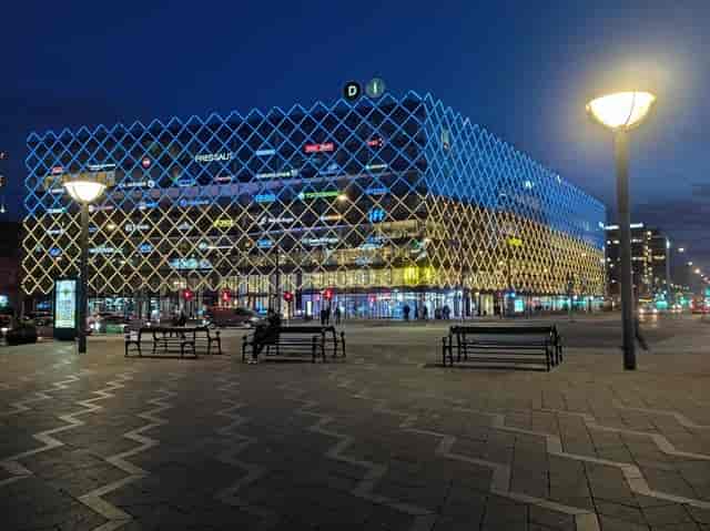 Modern venue illuminated at night for Copenhagen Pride events, featuring a striking geometric facade.