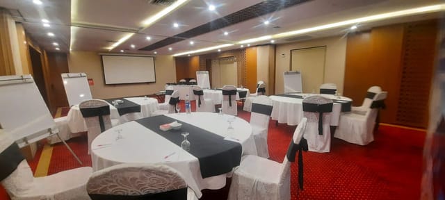 Premier meeting room in Ramada Lahore with round tables for workshops and conferences.