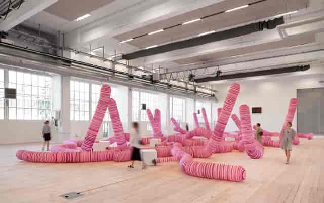 Interactive art installation in vibrant pink at Copenhagen Contemporary event space.