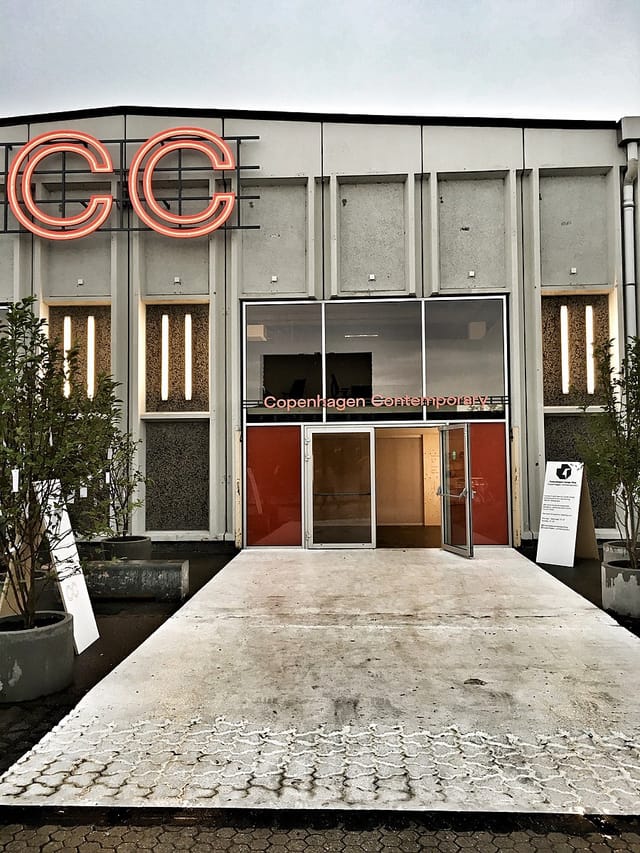 Copenhagen Contemporary entrance with sleek glass doors, ideal for art events and exhibitions.