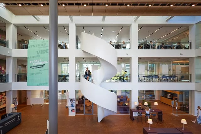 Modern multi-level event space with a spiral staircase for conferences and gatherings.