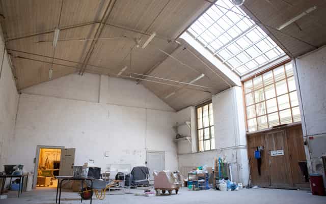 Spacious assembly hall at Royal Danish Academy for creative events and workshops.