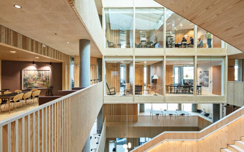 Modern open office with glass walls, ideal for workshops and networking events.