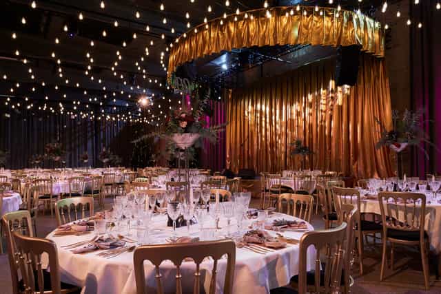 Elegant dinner event space at Centralen, featuring round tables and warm lighting.