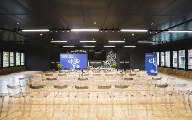 Modern meeting room with acrylic chairs set for a presentation in Talent Garden Copenhagen.