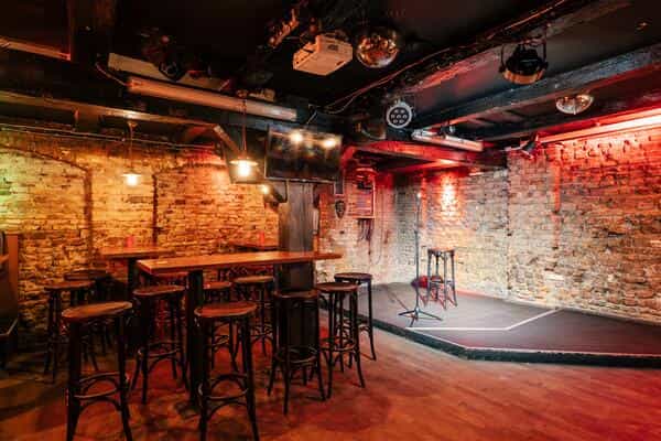 Intimate cocktail bar with exposed brick, ideal for small meetings and casual events.