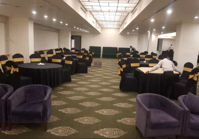 Platina Ballroom at Indigo Hotel, elegant setup for formal events with gold-accented tables.