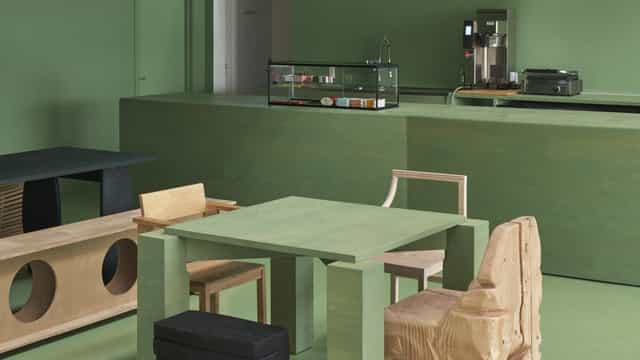 Modern minimalist meeting space at Café Spirrevippen, featuring green decor for brainstorming events.