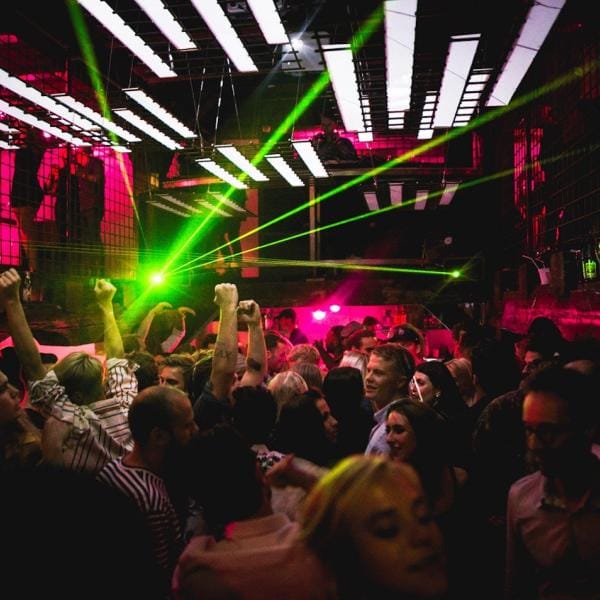 Vibrant nightclub scene at The Jane with energetic dancing under colorful lights.