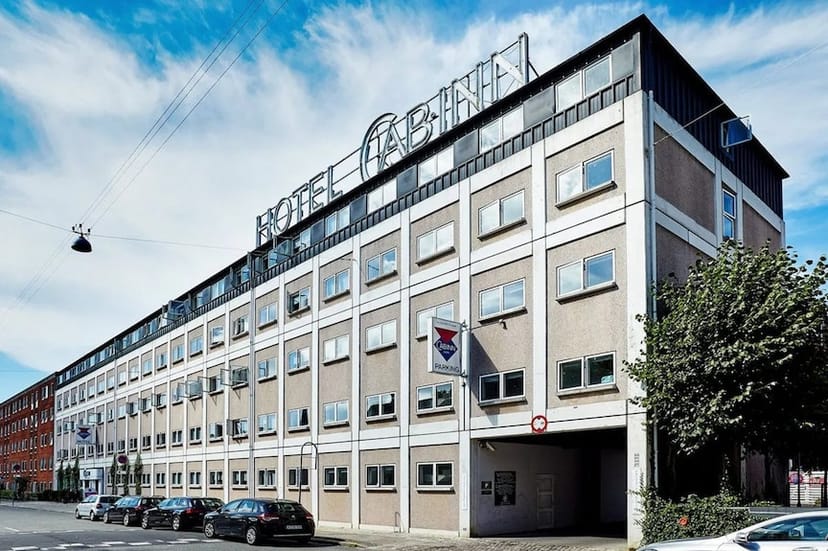 Modern CABINN Aalborg hotel with ample windows for meetings and events in urban setting.