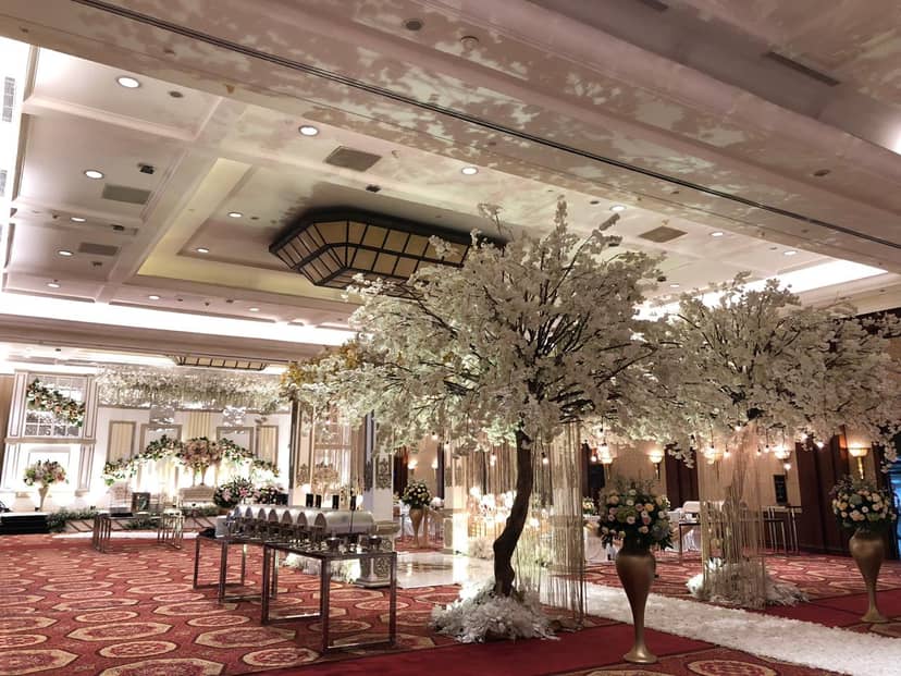 Elegant ballroom with cherry blossom trees for luxurious weddings and galas.