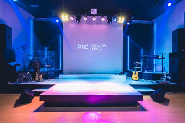 Versatile event space at Hotel Arwana with polished stage for corporate events.