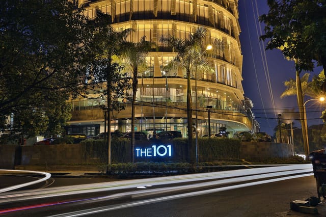 "Gloria Hall at The Tribrata: modern venue for corporate events, illuminated nightscape."
