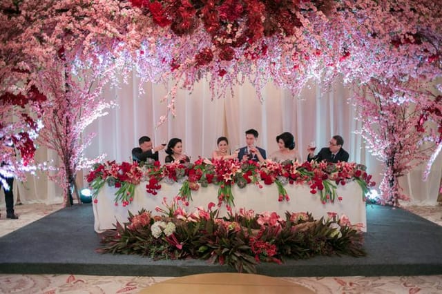 Elegant wedding table with vibrant flowers in romantic event setting at Gloria Hall.