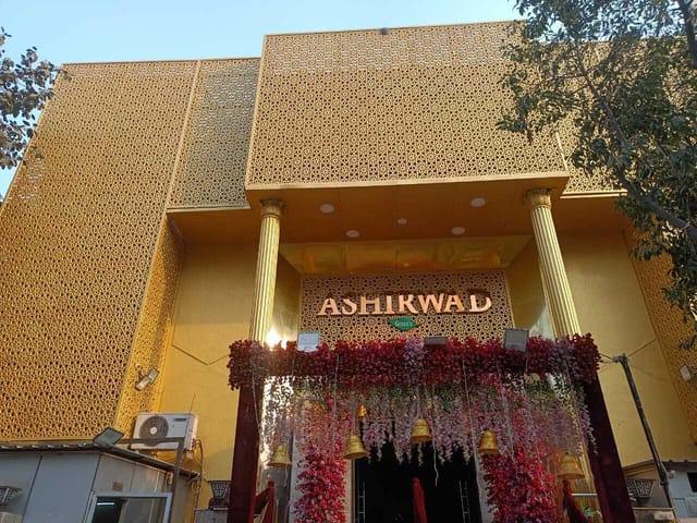 Vibrant Ashirwad Party Hall with floral entrance, ideal for weddings and celebrations.