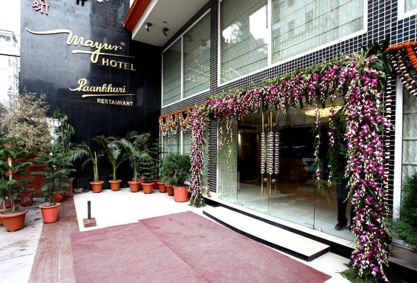Mayur Hotel entrance with floral decor, ideal for corporate events and gatherings.