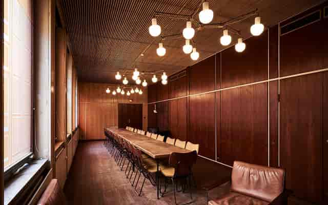 Spacious meeting room with wooden table, ideal for collaborative brainstorming sessions.