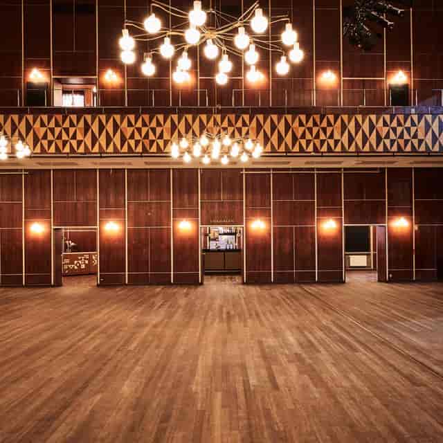 Spacious VEGA Lounge with wooden accents, perfect for events like conferences and receptions.