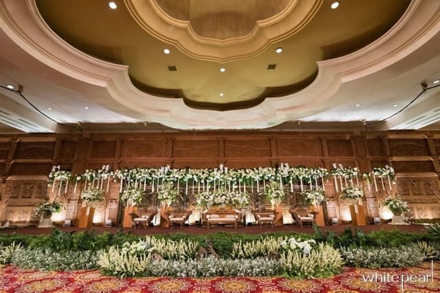 Ritz-Carlton Grand Ballroom with floral stage, ideal for weddings and corporate events.