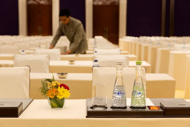 London Meeting Room at Raffles Jakarta with white seating, elegant decor for events.