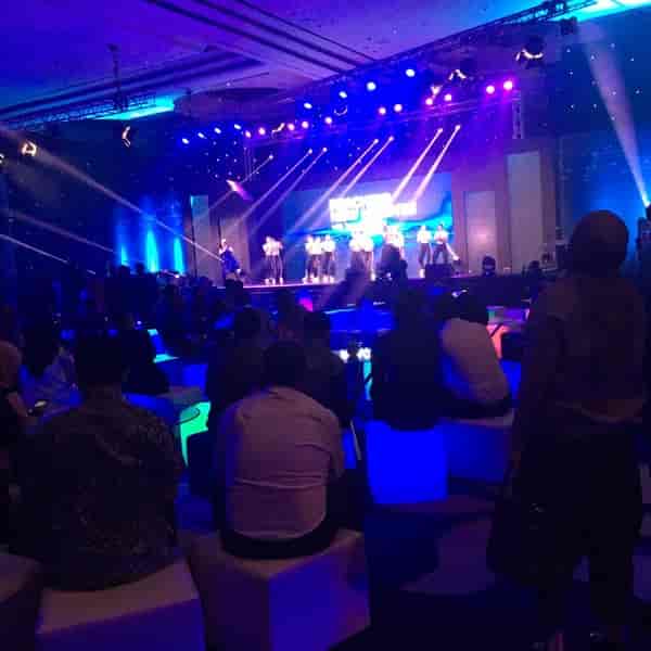 Dian Ballroom in Raffles Jakarta, vibrant event space with dynamic stage lighting and performers.
