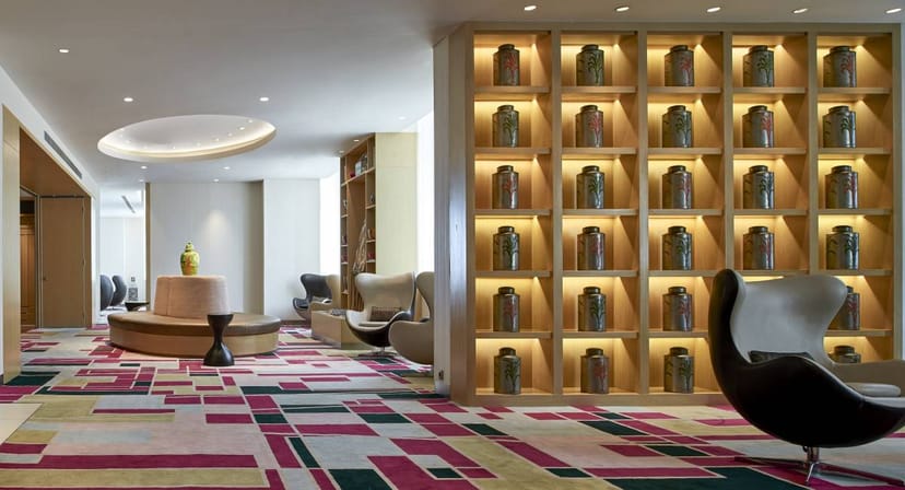 Modern event space in Pullman Jakarta, featuring sleek seating and vibrant carpet for networking.