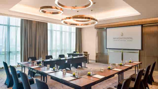 Modern conference room in InterContinental Jakarta with U-shaped seating for corporate events.