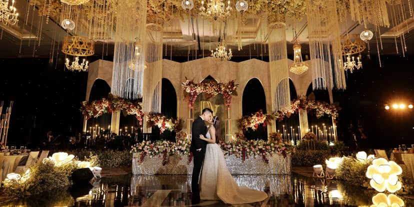 Grand Ballroom Fairmont Jakarta wedding with floral decor and chandeliers, luxurious venue.