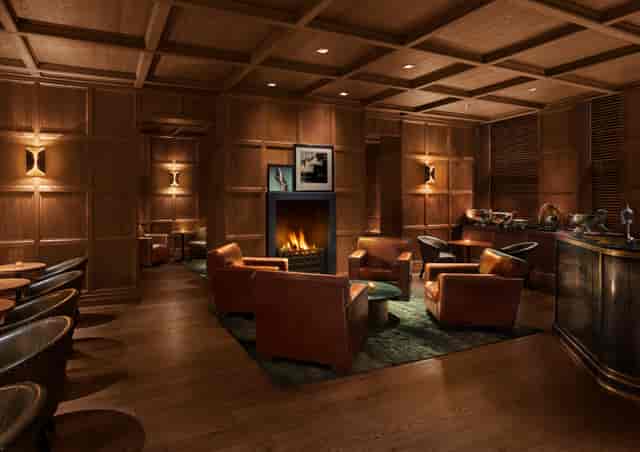 Sophisticated Punch Room lounge with warm wood paneling for networking events.