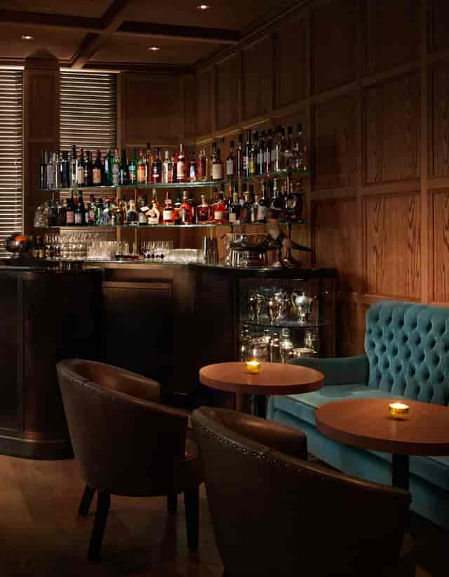 Sophisticated Punch Room bar with warm wood paneling, ideal for networking events.