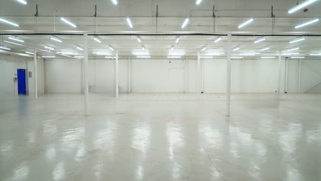 Spacious SCRUM Studios warehouse with polished floors, ideal for trade shows and events.