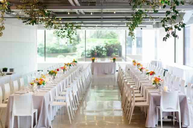 Elegant indoor event space with long tables for corporate dinners or functions.