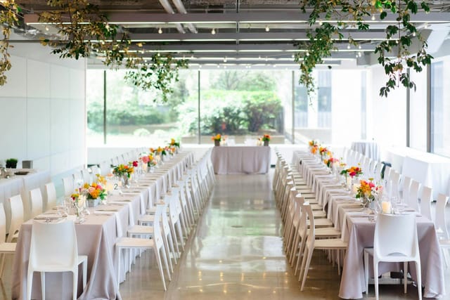 Elegant indoor event space with long tables for corporate dinners or functions.
