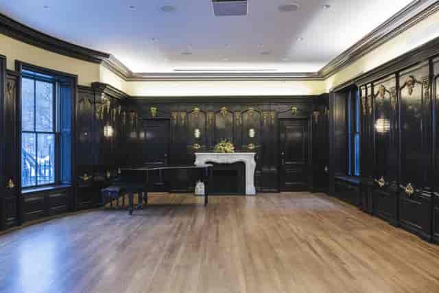 Elegant conference room with dark walls, natural light, perfect for intimate events.