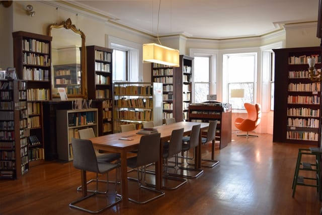 Reading Room in French Library, wooden table, ideal for meetings and brainstorming sessions.