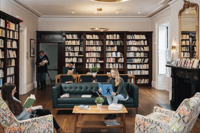 Cozy meeting space in French Library ideal for workshops and gatherings with inviting sofas.