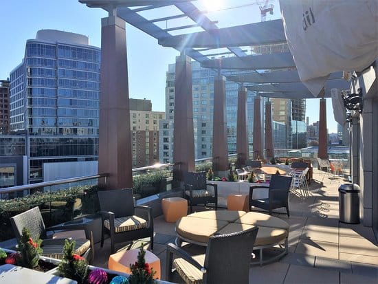 Stylish rooftop terrace at Residence Inn Boston for networking events with city skyline views.