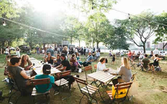 Esplanade Beer Garden with string lights, lively outdoor social event space for gatherings.