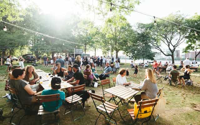 Esplanade Beer Garden with string lights, lively outdoor social event space for gatherings.