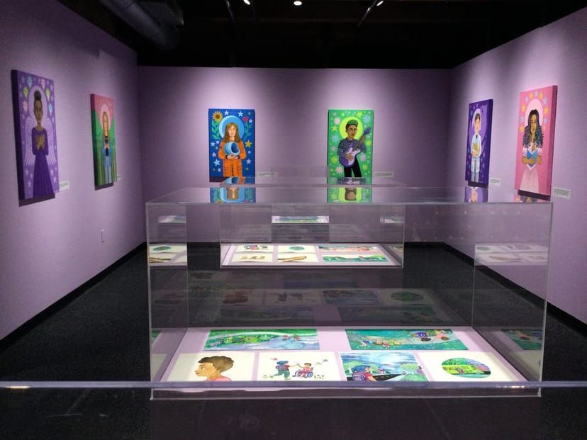 Vibrant art exhibition space with colorful portraits at Boston Children's Museum.