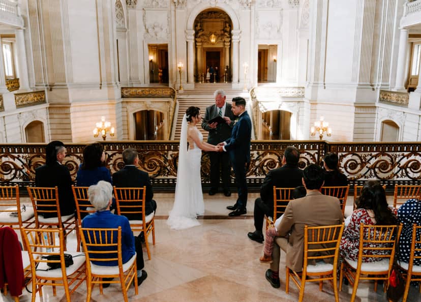 Elegant wedding ceremony in Mayor's Office, San Francisco, with classic architecture and natural light.