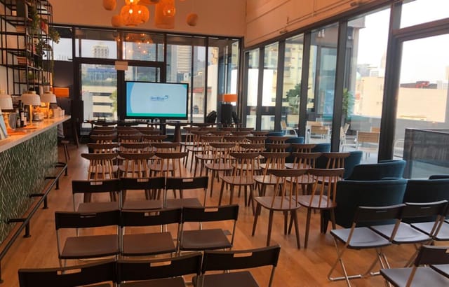 6-16 Pax Meeting Room at The Hive Carpenter, featuring a large screen for presentations.