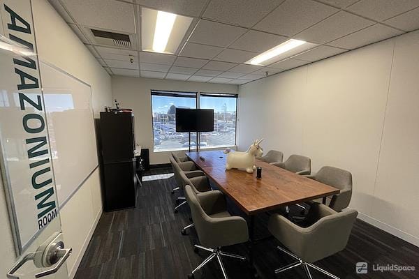 Private office meeting room with large screen, ideal for professional events and collaboration.