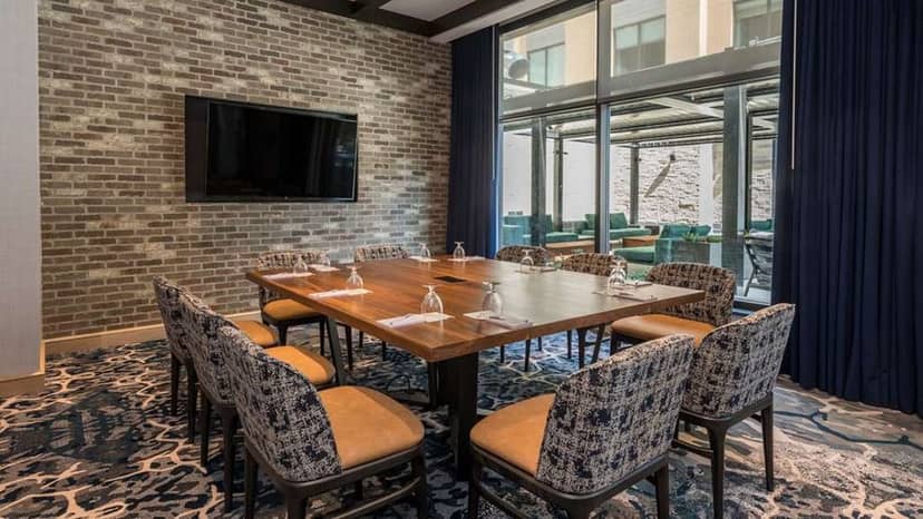 Conference room at Hilton Garden Inn Boston Canton with modern decor, ideal for meetings and events.
