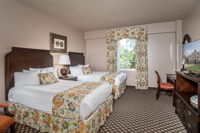 Minuet Room at The Menger Hotel with two beds, ideal for meetings and conferences.