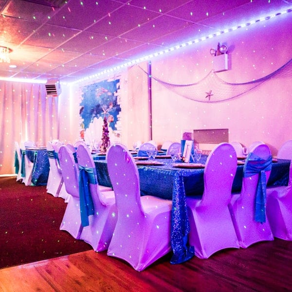 Elegant banquet hall with sequined blue linens, perfect for weddings and formal events.