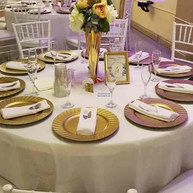 Elegant dining setup in City Banquet Hall with luxurious gold decor for special events.