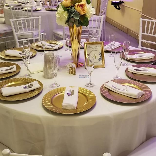 Elegant dining setup in City Banquet Hall with luxurious gold decor for special events.